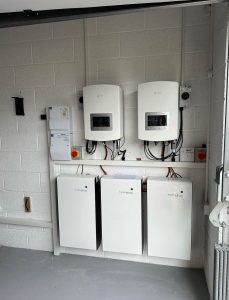 A Puredrive lithium-ion battery system installed in a home garage, showcasing sleek design and practicality.