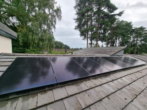 A modern solar panel installation on a residential roof under a clear sky, representing efficient solar energy capture.